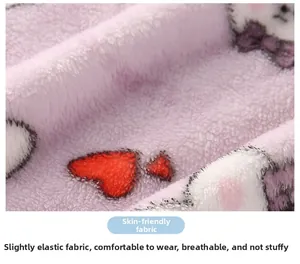 Macro detail of soft purple fleece fabric featuring red hearts and cute kitten patterns