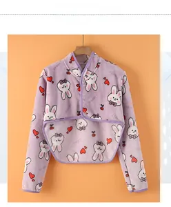 Detail of purple flannel shoulder warmer with cartoon rabbit pattern and button closure