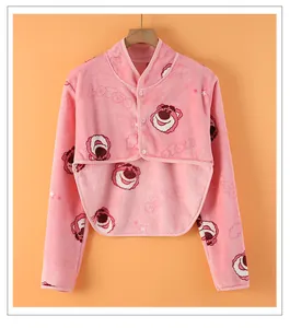 Close-up of pink fleece shoulder wrap with embroidered Lotso bear and button closure