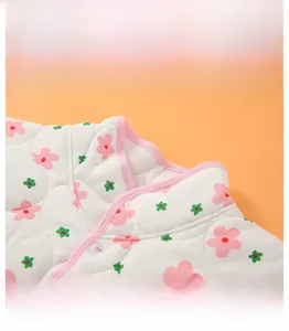 Detail of quilted shoulder wrap featuring a floral pattern and protective stand collar