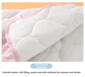 Macro shot of thick three-layer quilted fabric with cute rabbit print for warm baby vests
