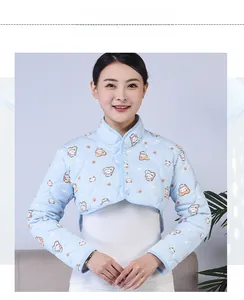 Detailed front view of a quilted blue shoulder warmer with cute cartoon cat prints and buttons