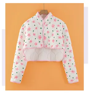 Detail of pink floral quilted shoulder warmer with soft padding and button closure