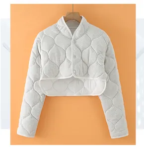 Detail of grey quilted thermal shoulder wrap showing the onion quilt texture and buttons