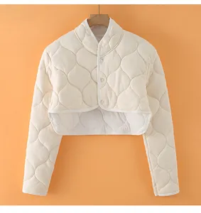 Detailed quilted texture and button closure on an oatmeal thermal shoulder wrap