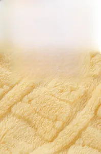 Macro detail of thick yellow flannel fabric with embossed check texture for warmth