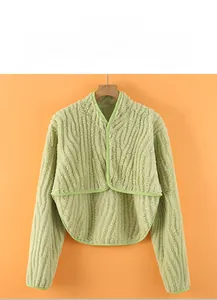 Detail of light green flannel shoulder warmer with snap buttons and wavy texture