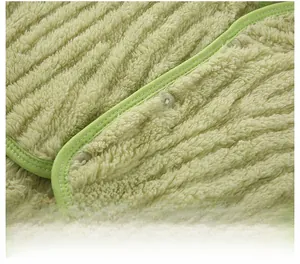 Close-up of green plush neck warmer fabric with reinforced stitching and round snap button