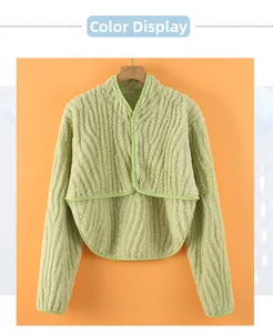 Detail of light green neck warmer cape with wave texture plush and green ribbon edging