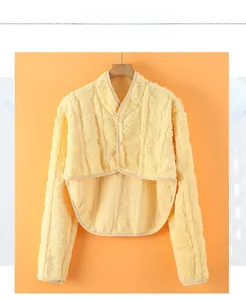 Detail of light yellow plush shoulder warmer with soft fleece texture for winter comfort