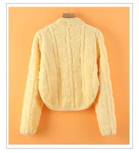 Detail view of bright yellow flannel shoulder protector with embossed bear patterns