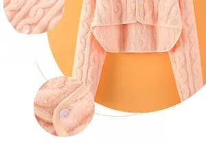 Detail of pink cable-knit flannel shoulder wrap showing soft fabric and fine stitching