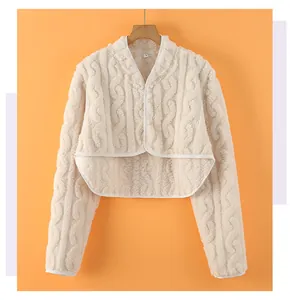 Detailed close-up of cream knit shoulder warmer showing plush lining and size L label