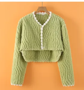 Detail of light green faux fur postpartum shoulder warmer with white lace trim and V-neck