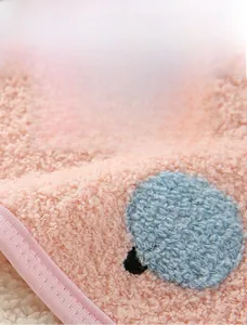 Detail of pink thick fleece fabric showing soft texture and thermal insulation properties
