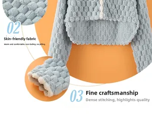 Close-up of sky blue waffle textured shoulder warmer with soft white sherpa lining