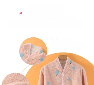 Close-up of pink polka dot coral fleece shoulder warmer with stand collar and white buttons