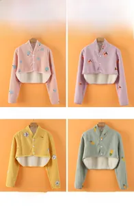 Detail view of thickened plush shoulder warmers in four cartoon fruit and animal patterns