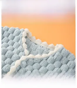 Close-up of blue plush shoulder warmer featuring square textures and round neck with lace trim