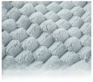 Macro shot of breathable light blue quilted fleece fabric with a white button detail