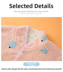 Detailed close-up of pink fleece shoulder wrap with blue dot pattern and soft lining