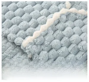 Close-up of light blue waffle fleece shoulder wrap with white wavy lace and button