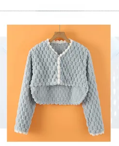 Detailed close-up of light blue coral fleece shoulder protector with bubble lattice texture