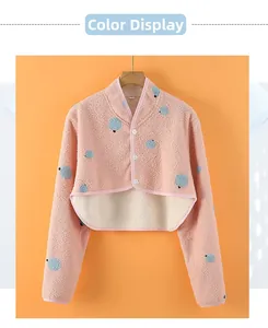 Detail of pink plush shoulder warmer with blue dots and single-breasted white buttons