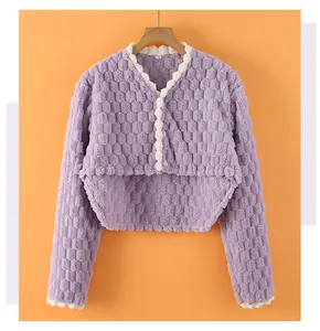 Detail of lavender plush thermal shoulder wrap with waffle texture and ruffled edges