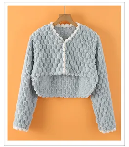 Detail of light blue thermal shoulder wrap featuring textured waffle fabric and lace trim