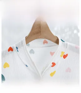 Detail of stand collar design and colorful heart prints on cotton gauze shoulder wrap