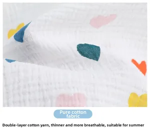 Close-up of lightweight double-layer cotton gauze fabric with colorful heart patterns