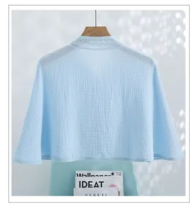 Detail view of sky blue breathable cotton gauze shawl with textured fabric finish