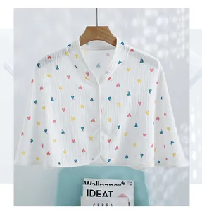 Detail of soft cotton muslin cape featuring cute prints and single-row button closure