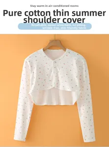 Detail of soft cotton shoulder wrap with pink strawberry print and button closure