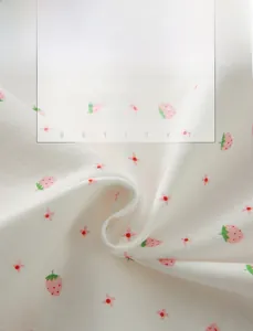 Detailed view of soft cotton fabric with strawberry and floral prints for breathable comfort