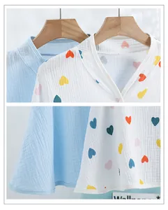 Close-up of soft cotton gauze nursing shawl fabric texture and delicate V-neckline detail