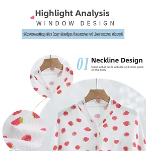 Close-up of neckline design on white cotton gauze shawl with red strawberry print