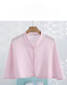 Close-up of pink double-layer cotton gauze postpartum shawl with button detail