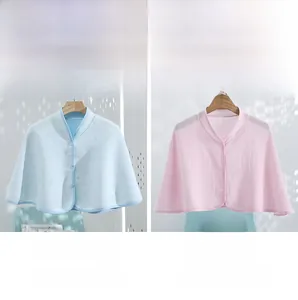 Detail of cotton nursing shawls in blue and pink with button design and padded texture