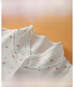 Detail of the stand-up collar with strawberry prints on the soft cotton baby shoulder wrap
