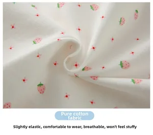 Close-up of soft cotton fabric with pink strawberry print and breathable knitted texture