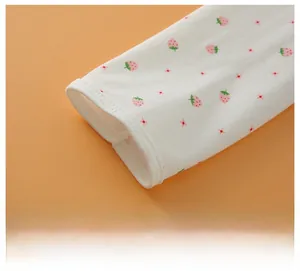 Detailed macro view of four-needle six-thread stitching on pink strawberry printed cotton fabric