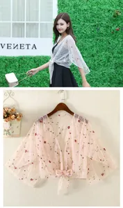 Detail of sheer mesh sunscreen cardigan with delicate floral embroidery and ribbon tie