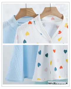 Detail of soft cotton muslin top featuring colorful heart prints and smooth round neckline