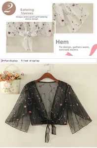 Detail of embroidered floral mesh sun protection shawl with batwing sleeves and tie hem