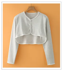 Detail of light grey cotton shoulder wrap with white piping and clear buttons