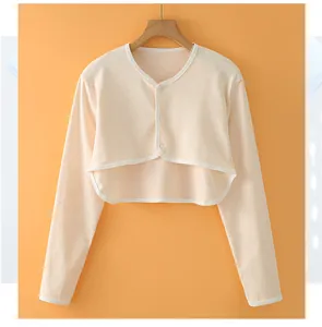 Detail of soft knitted cotton shoulder wrap with round neck and three button closure