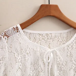 Women's summer white lace cardigan with delicate floral patterns and silk bow tie detail