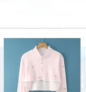 Detail of baby pink cotton shoulder guard with rabbit print and button closure